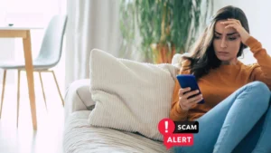 A lady reading the alert message on her mobile