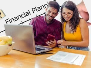 A smiling couple planning their finances with a laptop, calculator, and documents on the table, discussing their financial plan.