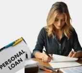 Best Personal Loans : Young woman carefully reviewing personal loan documents at her desk.