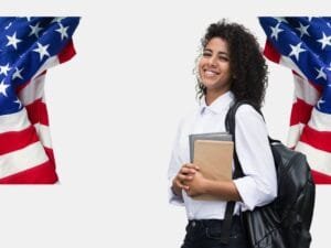 A smiling student holding books and a backpack, standing between two American flags, representing Student Loan Forgiveness in the U.S.