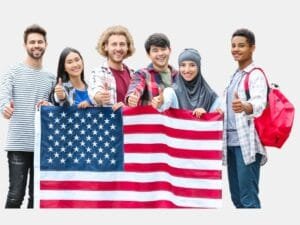 A diverse group of smiling students holding an American flag and giving a thumbs-up, symbolizing hope and opportunities through Student Loan Forgiveness in the U.S.